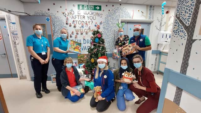 Manager Simon Howes from Tesco Extra in Banbury with staff from the Horton children's ward