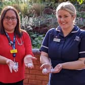 Katharine House doctor Carrie Anderson and Inpatient Unit Ward Manager Abbie Hessey hold a candle for this year’s Lights of Love event