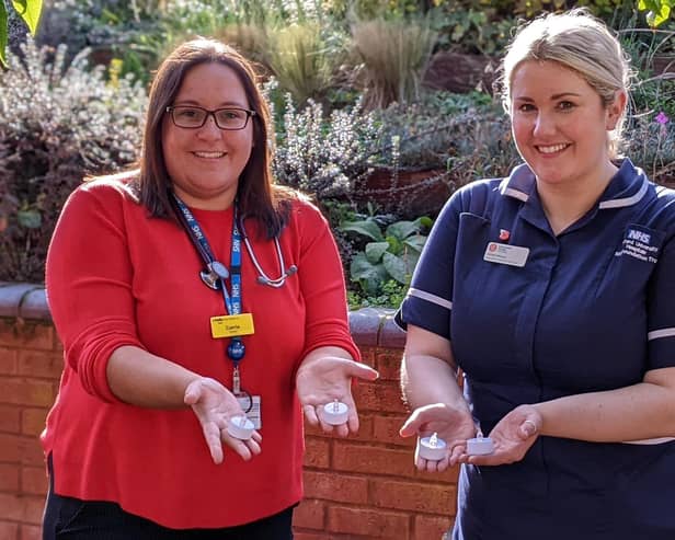 Katharine House doctor Carrie Anderson and Inpatient Unit Ward Manager Abbie Hessey hold a candle for this year’s Lights of Love event