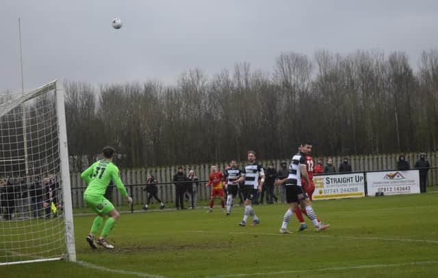 Aidan Scott-Wheeler (centre in distance) sees his cross float into the net. Photo: BUFC.