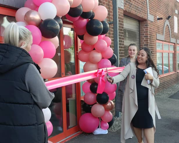 Danielle Buick cuts the ribbon at the grand opening of her new dance studio.