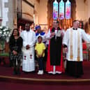 Reverend Kudzayi with his wife, Cynthia and two children next to the Bishop of Dorchester The Rt. Rev. Gavin Collins (in red) and Revd. Cannon Toby Wright.