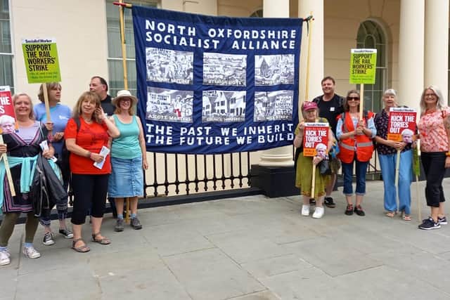 Members of the North Oxfordshire Socialist Alliance are pictured gathering before the start of the London demo
