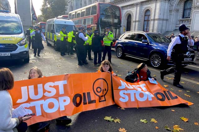 Members of Just Stop Oil block off the road in Whitehall this morning.