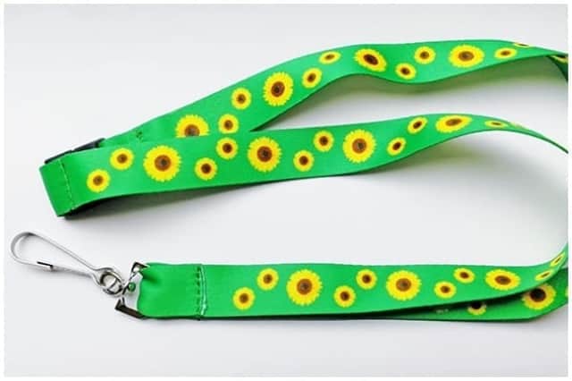 These lanyards are bright green in colour and decorated with a sunflower design (Photo: RNIB)