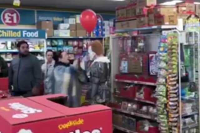A video still of a mum in heated confrontation with a man dressed as a clown in Poundland