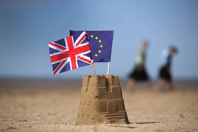 In this photo illustration the flag of the European Union and the Union flag sit on top of a sand castle on a beach on May 09, 2016 in Southport, United Kingdom