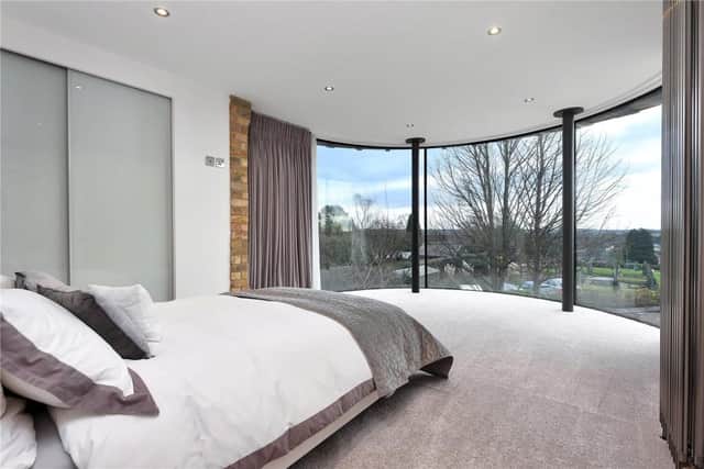 The first-floor bedroom has a full-height, curved-glass wall and far-reaching views. (Picture: Rightmove)