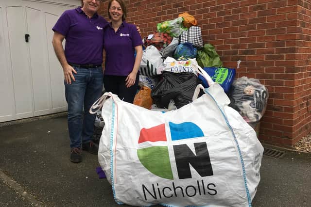 Kirstie Darnell and Simon Richards with the pile of bagged shoes ready for shipment to South Africa
