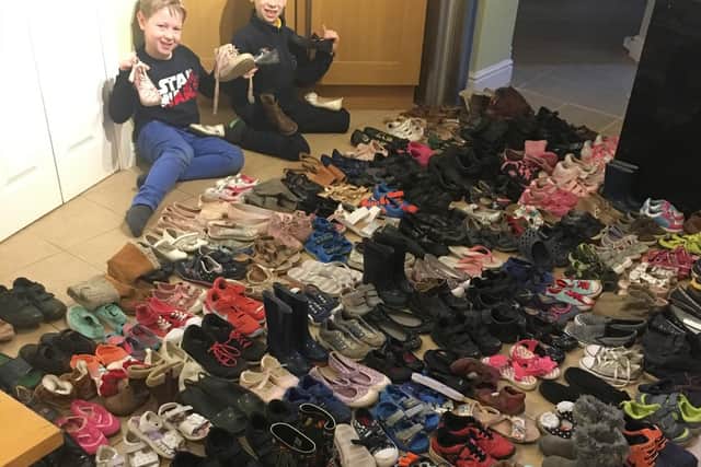 Kirstie Darnell's sons Oliver and Harvey helped organise the donated shoes. Photo courtesy of Kirstie