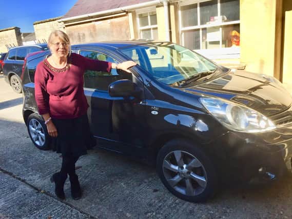 Anne Cooper next to her car which was fixed by the 'Good Samaritan' ambulance driver