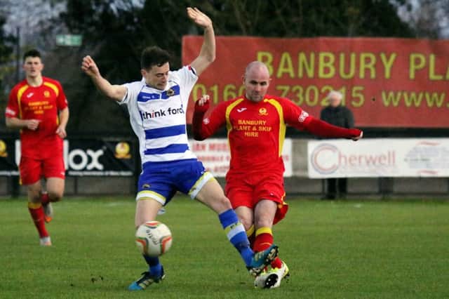 Banbury United's Tom Winters and Farnborough's Jack Barton compete for the ball
