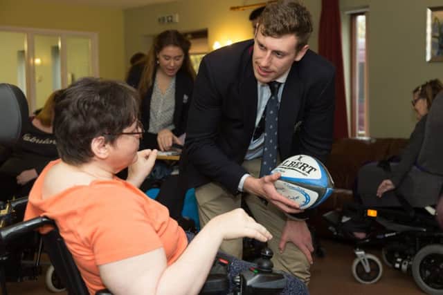 Oxford University men's rugby team captain Conor Kearns meets a resident at Agnes Court. Photo: Keith Barnes/Leonard Cheshire Disability NNL-171127-100033001