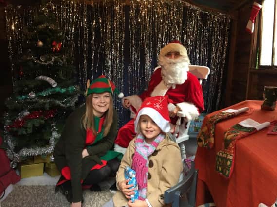 A happy visitor after meeting Santa Claus and his elf at Hempton's Christmas Bazaar last year