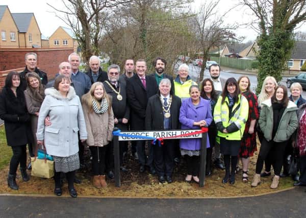 Family and colleagues of Cllr George Parish cutting the ribbon opening the road named in his honour at Banbury Rise development. NNL-170212-184255009