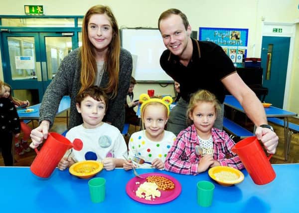 Jess de Ayala and Jamie Worth from Amazon Banbury with Leo Bell, six, Ruby Golder, six, and Kelsie Gillet-Hill, six, after helping out at William Morris Primary School's Magic Breakfast Club. Photo: Dave Fleming NNL-171112-170501001