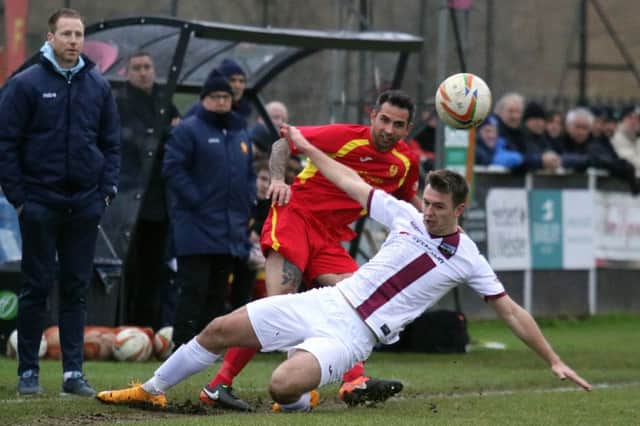 Banbury United's Darren Pond and Weymouth's Josh Carmichael compete for the ball