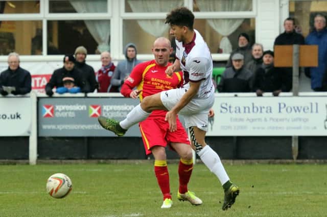 Banbury United's Tom Winters is thwarted by Weymouth's Calvin Brooks