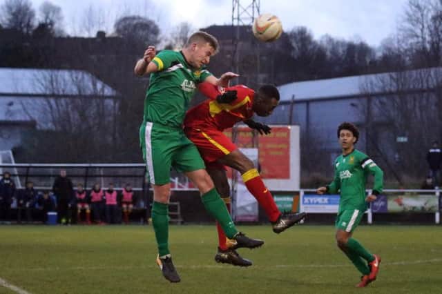 Banbury United's Leam Howards is beaten to a cross by Hitchin Town's Dan Webb