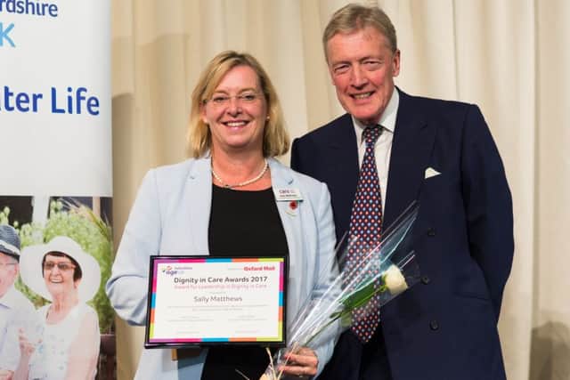 Sally Matthews from Highmarket House Care Home in Banbury receives the Dignity in Care Award from Oxfordshire's Lord-Lieutenant, Tim Stevenson OBE NNL-170512-113740001