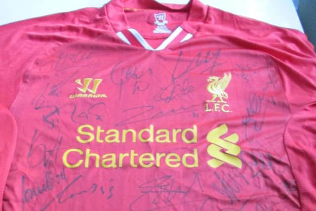 A Liverpool FC shirt sold by FA Premier Signings supposedly signed by the whole squad. Photo courtesy of Dorset County Council NNL-180115-152219001