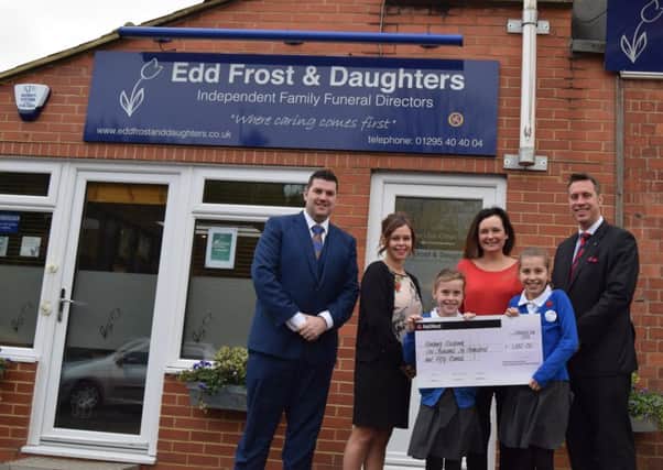 Funeral director Aaron Taylor, Sarah Marley, Sarah Williams (Banbury Foodbank and Edd Frost. Lola and Daisy Frost with the cheque NNL-180130-102608001