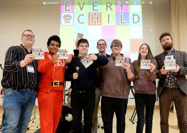 Andrew Smith from Barnardo's (left), NOA head of music Ben Judson (centre) and music teacher James Stevenson (right) with children from the school and the Sycamore Centre holding the Every Child CD. NNL-180130-191410009