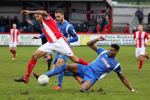 Brackley Town's Glenn Walker is tackled by Salford City's Michael Nottingham