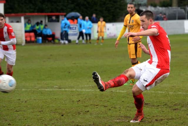 Aaron Williams scores from the penalty spot for Brackley Town against Sutton United