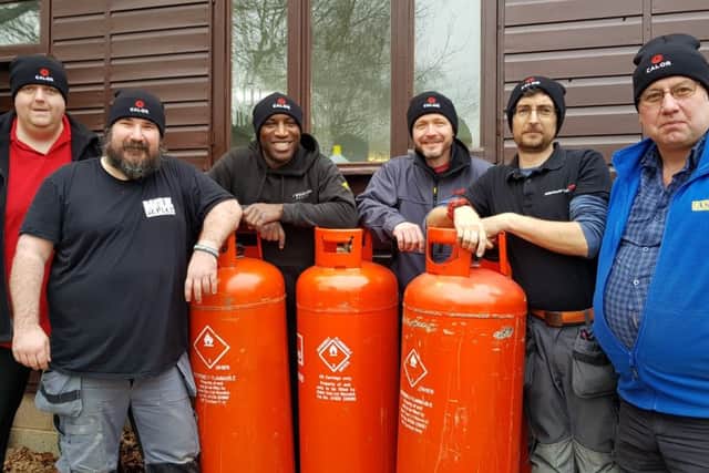 Members of the Heat for Good team celebrate the arrival of LPG storage cylinders care of Ian Digby, specifier sales manager at Calor Gas (far left). Photo: Viessmann NNL-181202-105943001