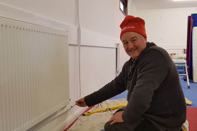 Kevin Bates of Witney Heating Services fitting donated Warmastyle radiators from QRL Radiator Group at the Lets Play disabled childrens centre. Photo: Viessmann NNL-181202-105955001