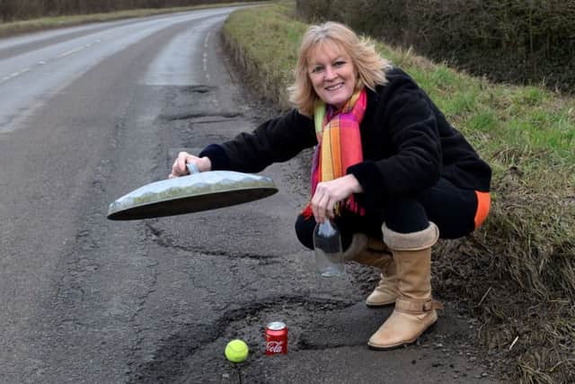 Banbury pothole measuring. Reporter, Roseanne Edwards on Broughton Rd near The Giant's Caves. NNL-180220-112456009