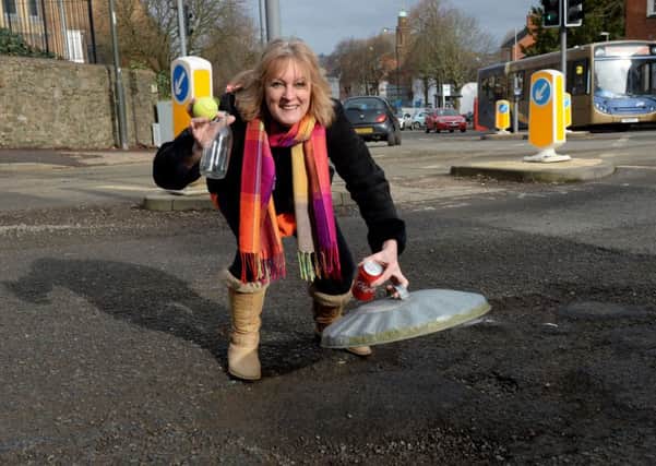 Banbury pothole measuring. Reporter, Roseanne Edwards at the Oxford Rd/Bloxham Rd junction. NNL-180220-112336009