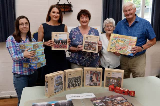 Piece Together puzzle club, Banbury, receives puzzles from Wentworth Puzzles. From the left, Sam Skeet, puzzler, Sarah Watson, Wentworth Puzzles director, Sue Riches, Piece Together founder, June Cox and John Herrington, puzzlers. NNL-170822-161649009