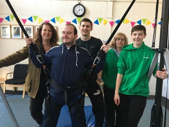 North Oxfordshire MP Victoria Prentis (far left) with members of Ricochet Trampolining Club, with blind member Tom Grant in the new bungee harness