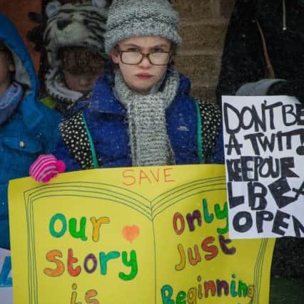 Protestors outside Brackley Library over severely reducing its opening hours. Photo by Rachel Page NNL-180203-161851001
