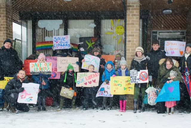 Protestors outside Brackley Library over severely reducing its opening hours. Photo by Rachel Page NNL-180203-161925001