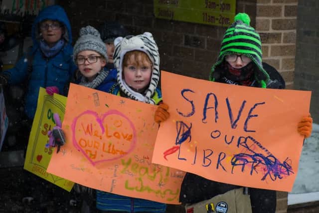 Protestors outside Brackley Library over severely reducing its opening hours. Photo by Rachel Page NNL-180203-161948001