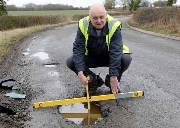 Mr Pothole, Mark Morrell, with potholes between Greatworth and Halse. NNL-180503-160407009