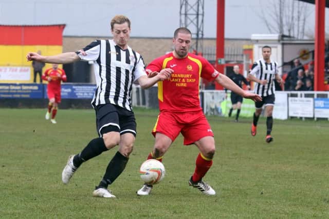 Banbury United's Paul Stonehouse and St Ives Town's Daniel Moyes challenge for possession