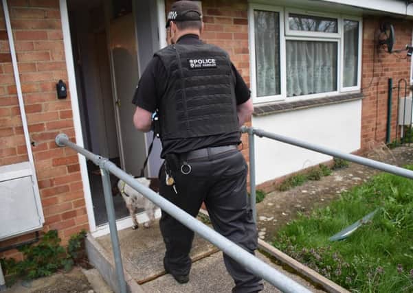 Drug detection dog enters a Banbury home after a number of raids across the town NNL-180418-125126001