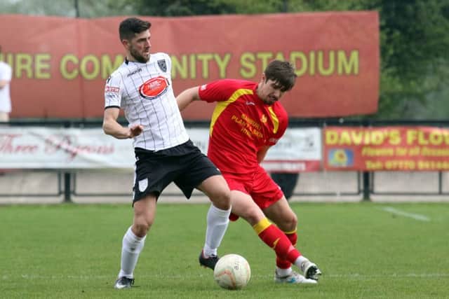 Banbury United's Jack Finch and Merthyr Town's Corey Jenkins compete for the ball