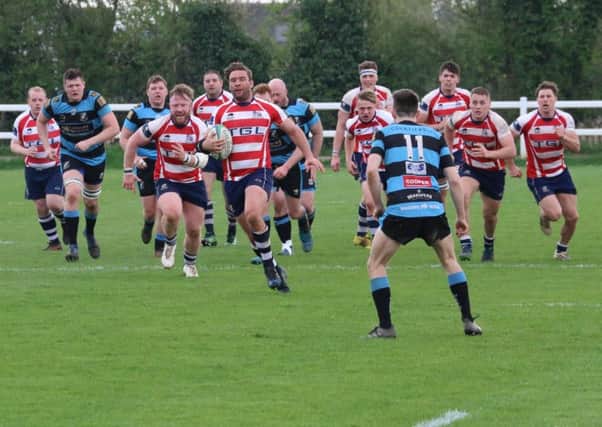 Banbury Bulls' player-coach Matt Goode leads the charge at Witney. Photo: Simon Grieve