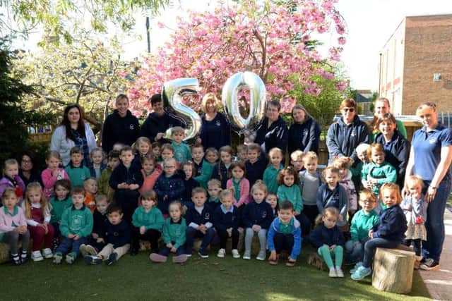 Little Oaks Pre-school, Brackley, 50th anniversary. Children a d staff with Setting Manager, Nikki Lloyd in the centre at the back. NNL-180105-142247009