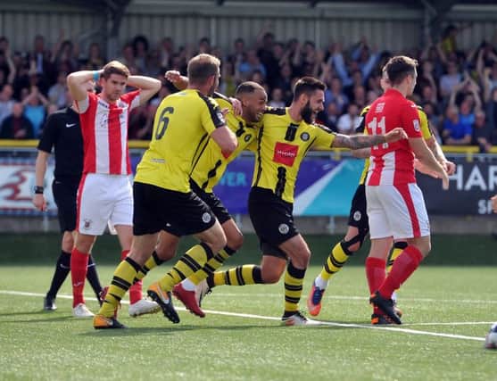 Brackley Town's Jimmy Armson and Adam Walker look on as Harrogate Town players celebrate Dominic Knowles' second goal of the game.  Photo: Tony Johnson