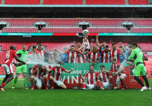 The Brackley Town squad celebrate after Sunday's dramatic victory at Wembley. Photo: Mike Capps