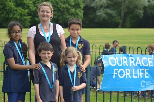 St John's Priory School headmistress Tracey Wilson with the pupils after the Race for Life for Cancer Research UK NNL-180619-113433001