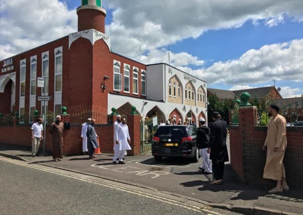 Mourners outside Banbury Mosque as Noreen Akhtar's hearse arrives for her funeral