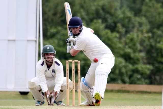 Oxford batsman Richard Musk deals with a delivery as Sandford St Martin wicket keeper Steven Dobson looks on