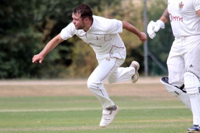 Banbury bowler Olly Wright sends down a delivery against Slough at White Post Road